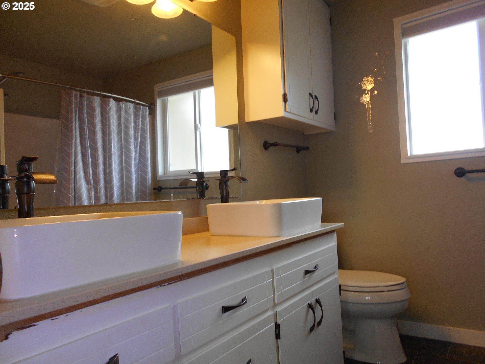 4565 Souza Street Eugene, OR 97402 - Photo 34 of 43 a bathroom with a sink a toilet and a window