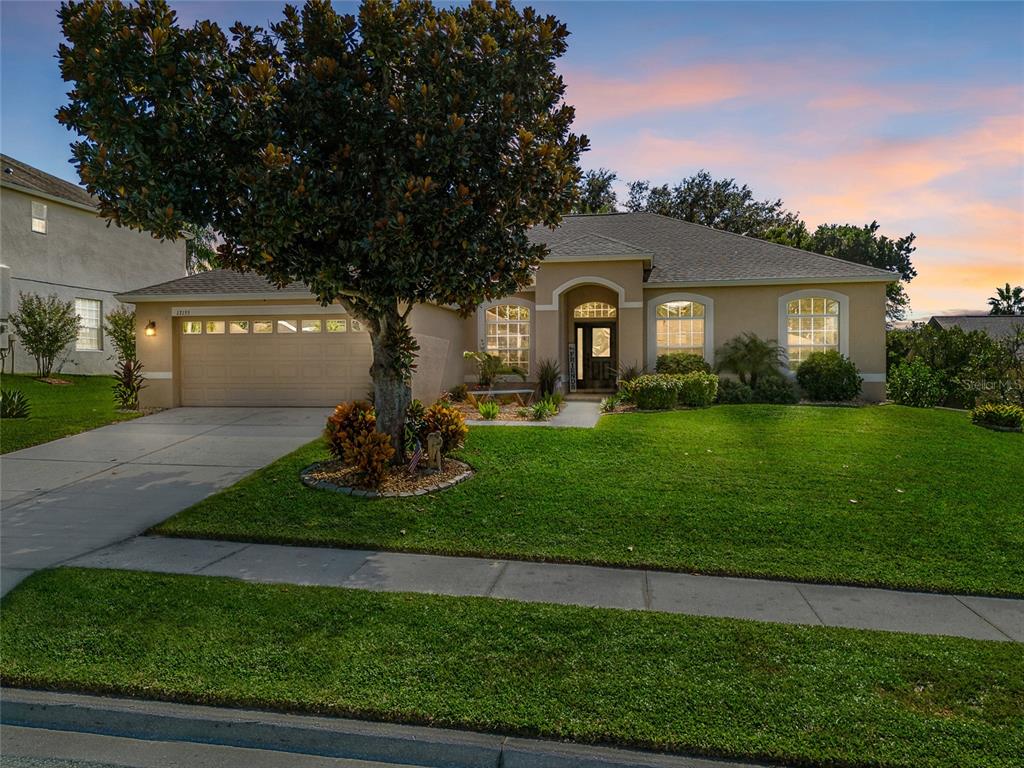 13155 Coldwater Loop Clermont, FL 34711 - Photo 1 of 1 a front view of house with yard and green space
