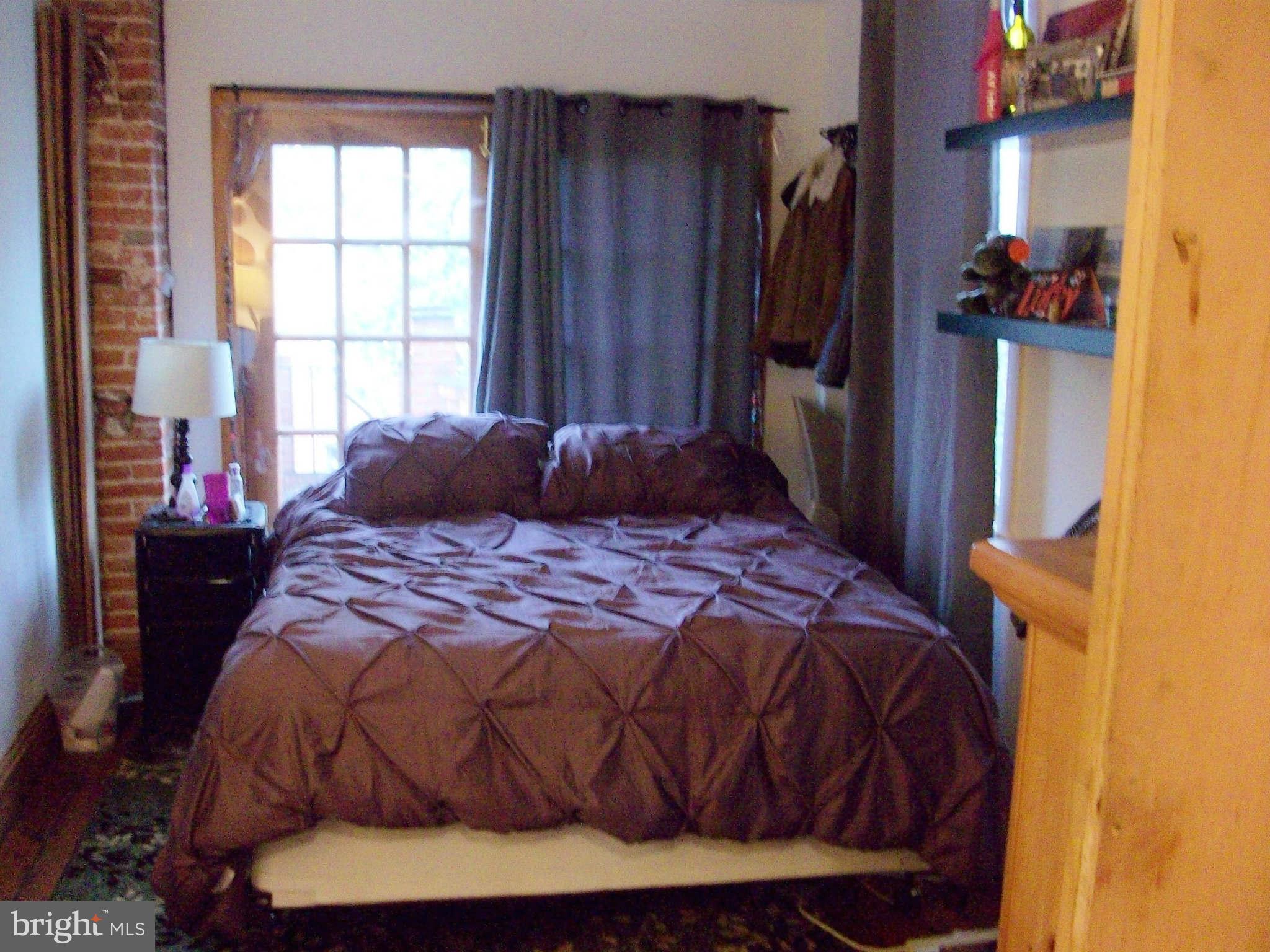 1265 Riverside Avenue Baltimore, MD 21230 - Photo 3 of 12 a bedroom with a bed and a window