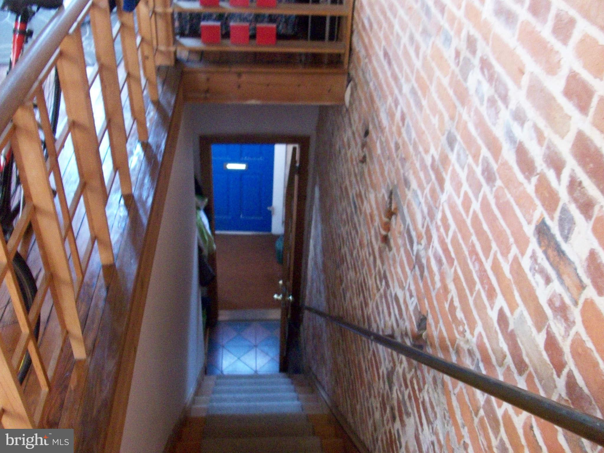 1265 Riverside Avenue Baltimore, MD 21230 - Photo 6 of 12 a view of a hallway with wooden floor and stairs
