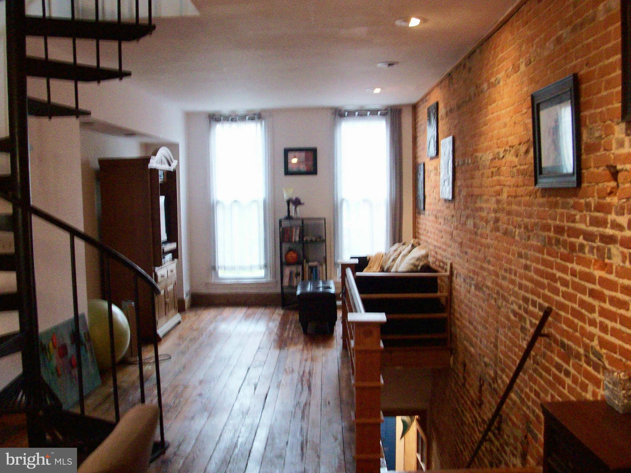 1265 Riverside Avenue Baltimore, MD 21230 - Photo 7 of 12 a living room with furniture and a flat screen tv