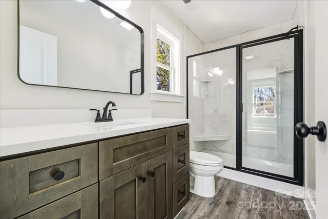 a spacious bathroom with a sink a toilet and shower