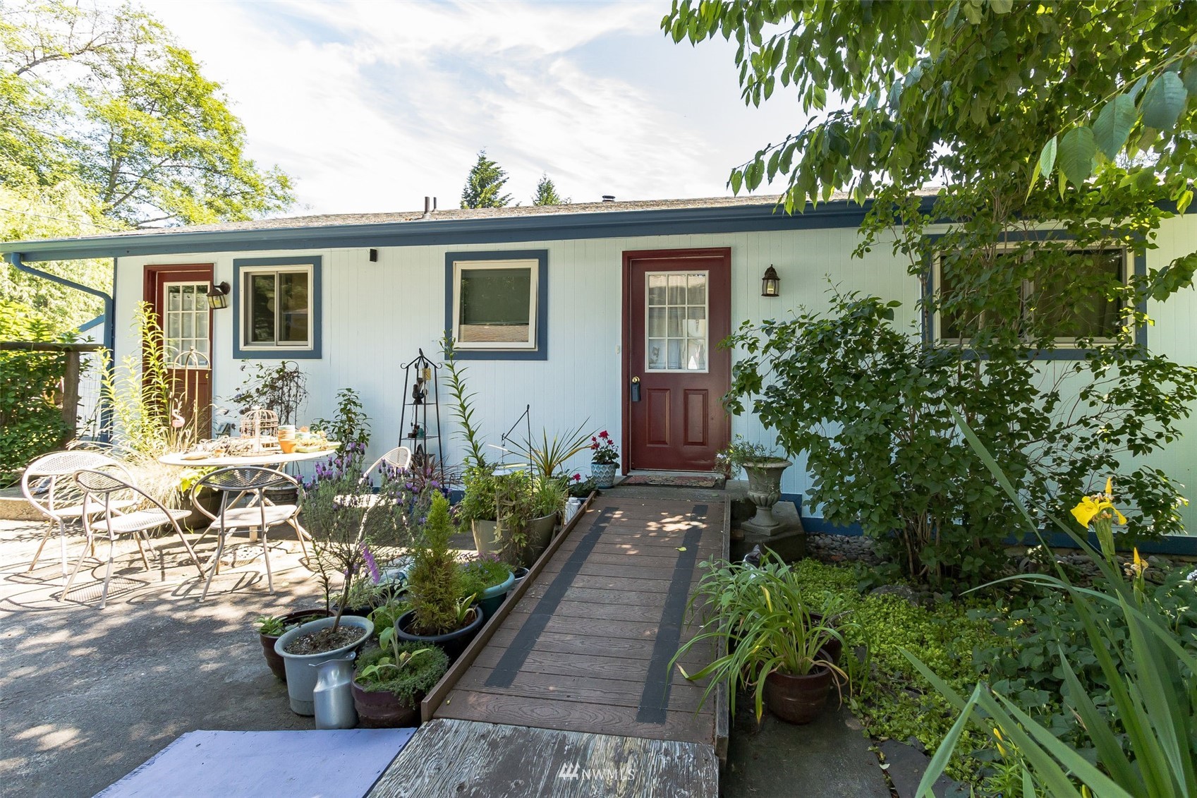 a front view of a house with a yard and a garden