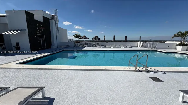 a living room with granite countertop kitchen island a sink and a stove