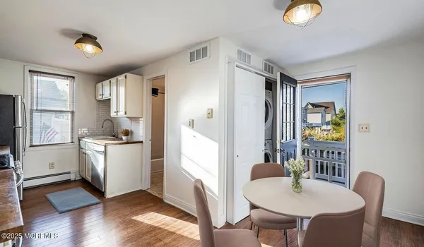 a kitchen with stainless steel appliances granite countertop a refrigerator a stove a sink dishwasher and white countertops with wooden floor