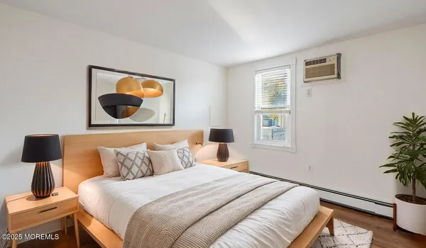 a bedroom with a bed and a potted plant