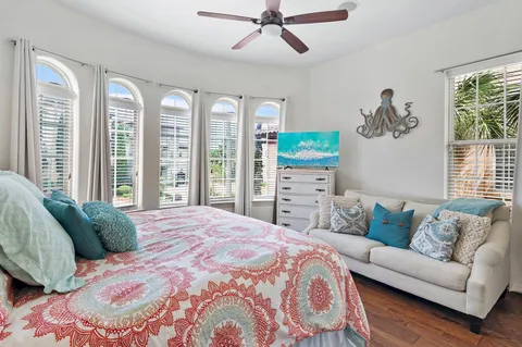 a large bed sitting in a bedroom next to a large window