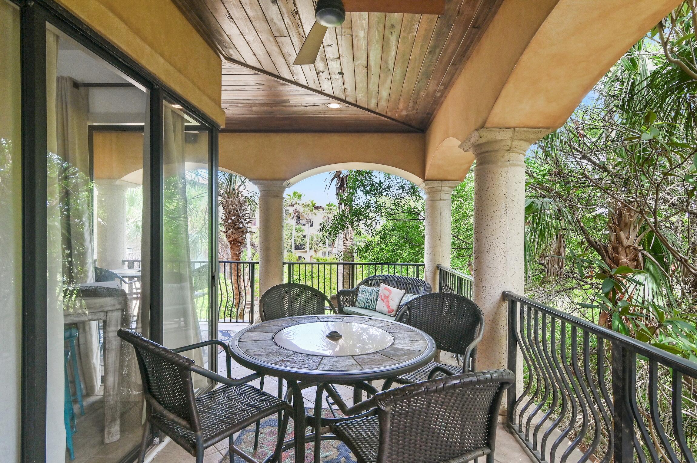 215 Rue St Tropez Miramar Beach, FL 32550 - Photo 27 of 46 a view of a patio with a table chairs and a backyard