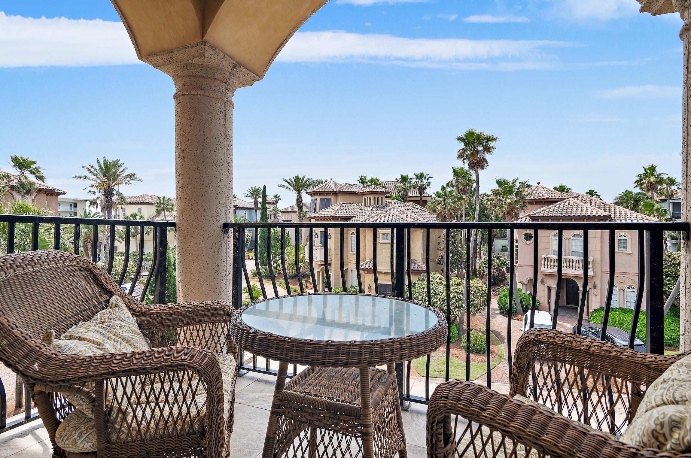 215 Rue St Tropez Miramar Beach, FL 32550 - Photo 31 of 46 a view of a balcony with a table and chairs