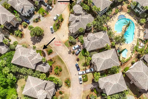 an aerial view of a house with a yard and pool