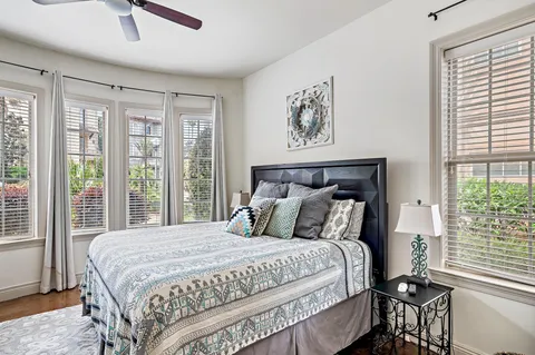 a bathroom with a granite countertop sink a toilet and shower