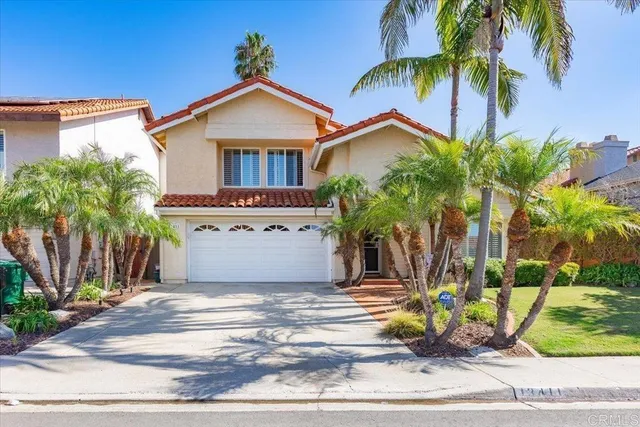 a view of a house with a yard and a palm tree