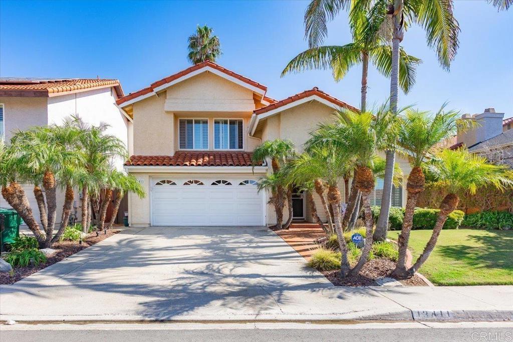 a view of a house with a yard and a palm tree
