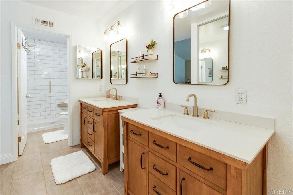 13411 Appalachian Way San Diego, CA 92129 - Photo 11 of 12 a bathroom with a sink double vanity and a mirror