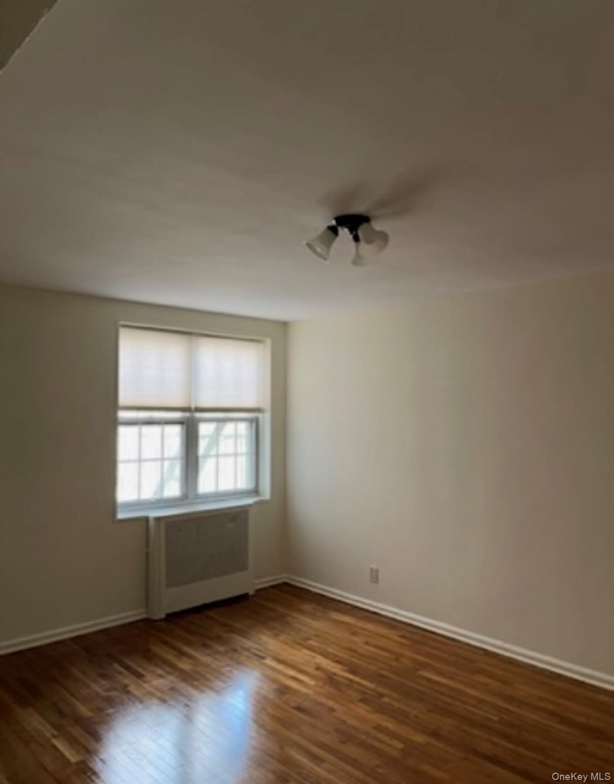 776 Bronx River Road, Unit B24 Bronxville, NY 10708 - Photo 5 of 9 Empty room with dark wood-style flooring and baseboards