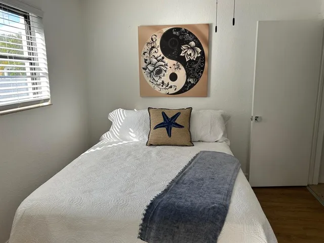 a bathroom with a granite countertop sink a large mirror and a bathtub