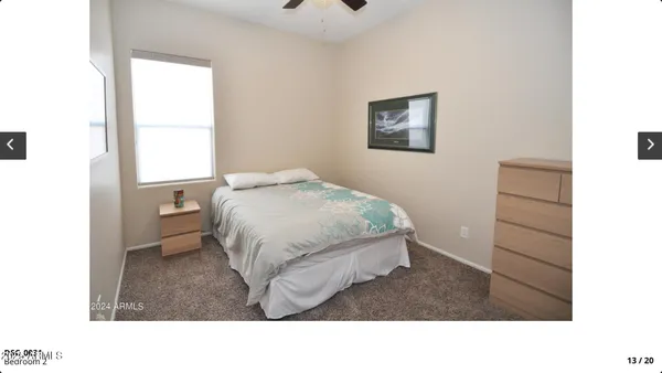 a living room with a bed and a window