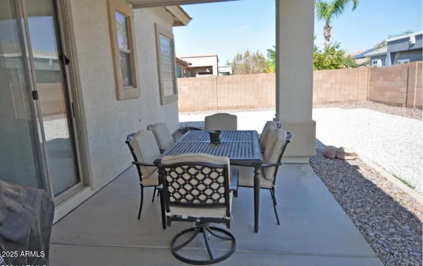 a view of a patio with table and chairs and potted plants