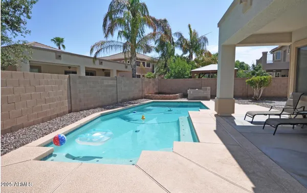 a view of backyard with swimming pool