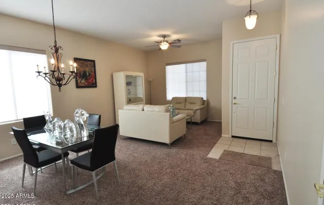 a living room with furniture and chandelier