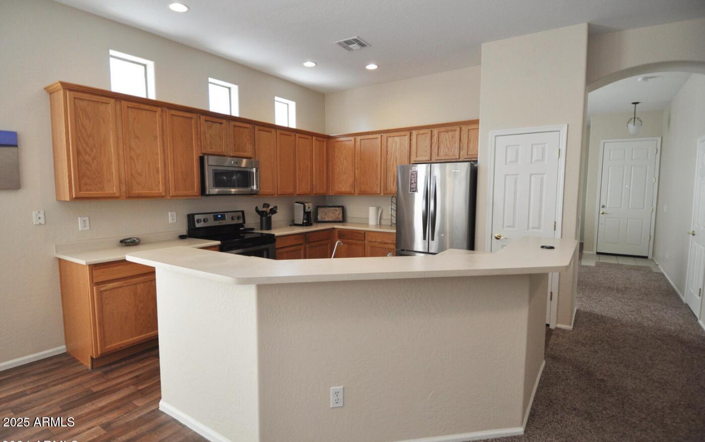 3530 East Los Altos Road Gilbert, AZ 85297 - Photo 6 of 20 a kitchen with stainless steel appliances a refrigerator stove microwave and sink