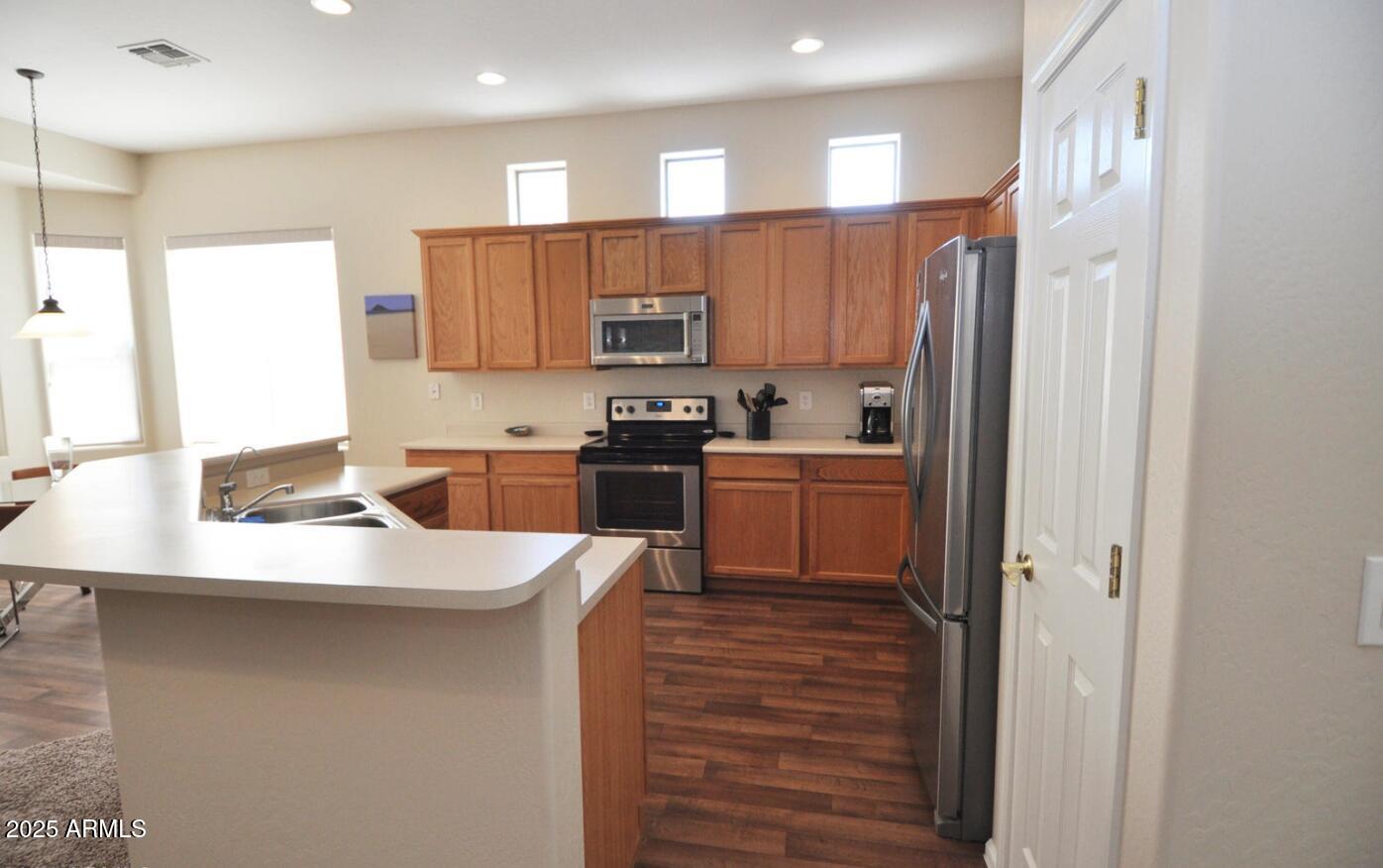 3530 East Los Altos Road Gilbert, AZ 85297 - Photo 7 of 20 a kitchen with stainless steel appliances granite countertop a sink a refrigerator and a stove