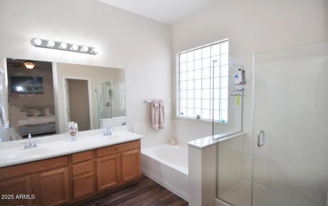 a bathroom with a large tub sink and mirror
