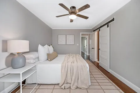a bedroom with a bed and a lamp