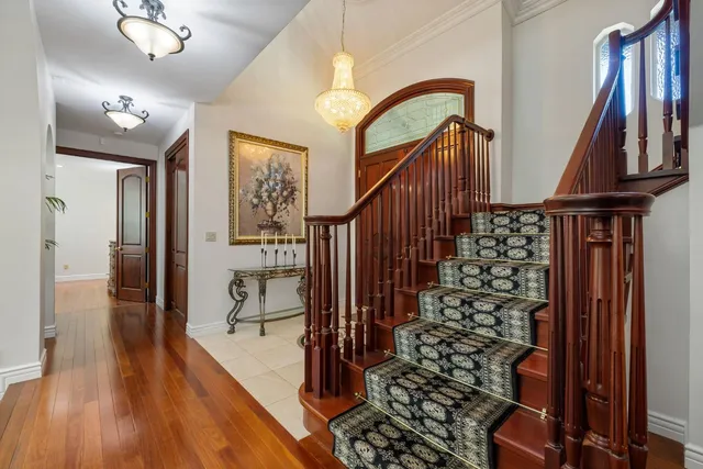 a dining room with furniture a chandelier and wooden floor