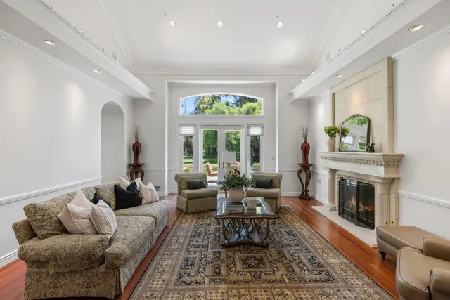 a view of a dining room with furniture a chandelier and wooden floor