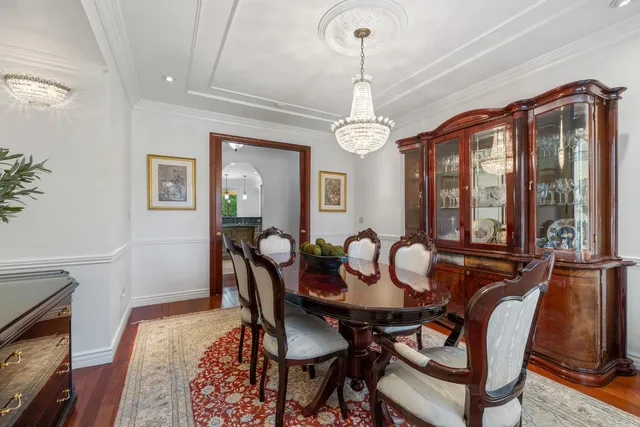 a kitchen with stainless steel appliances granite countertop a sink a stove and a wooden floor