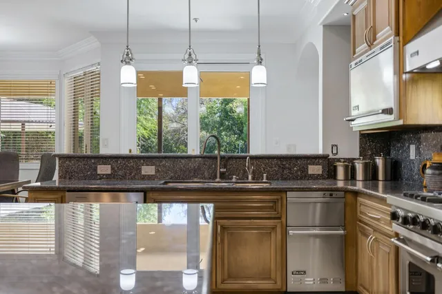 a bathroom with a granite countertop sink a toilet and shower