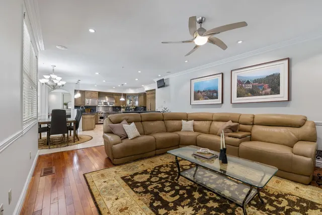 a view of hallway with stairs and wooden floor