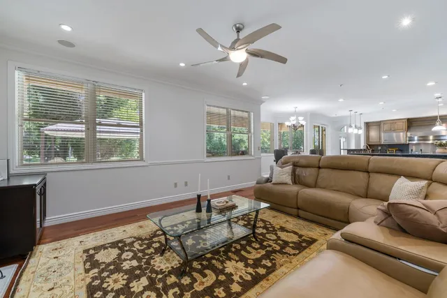 a view of a house with backyard and a tree