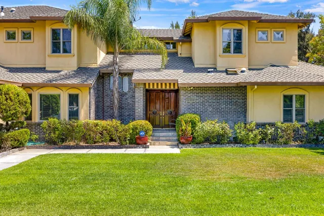 a living room with fireplace furniture and a chandelier