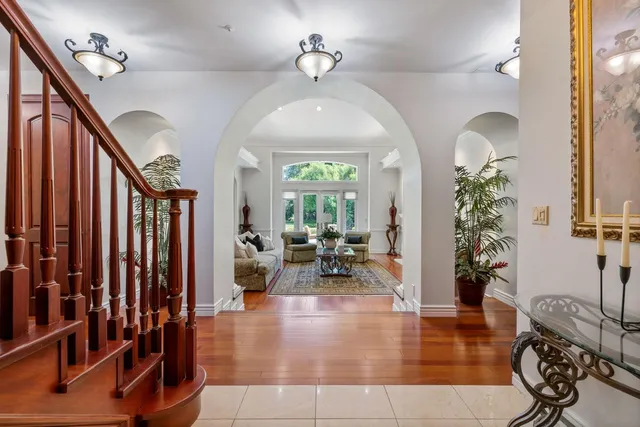 a living room with fireplace furniture and a large window