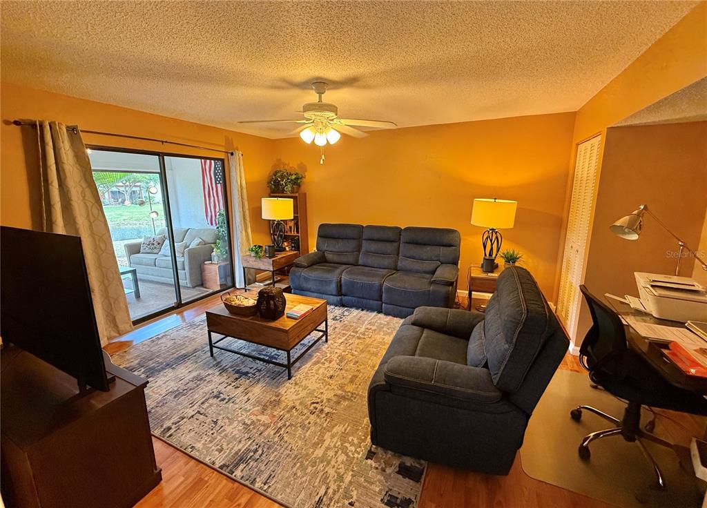 621 Spring Lakes Boulevard, Unit 621 Bradenton, FL 34210 - Photo 22 of 63 a living room with furniture and a flat screen tv