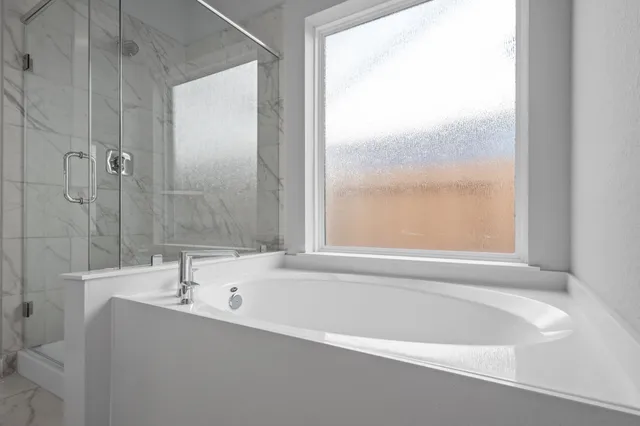 a bathroom with a shower and a door