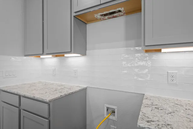 a kitchen with granite countertop a sink a center island and cabinets