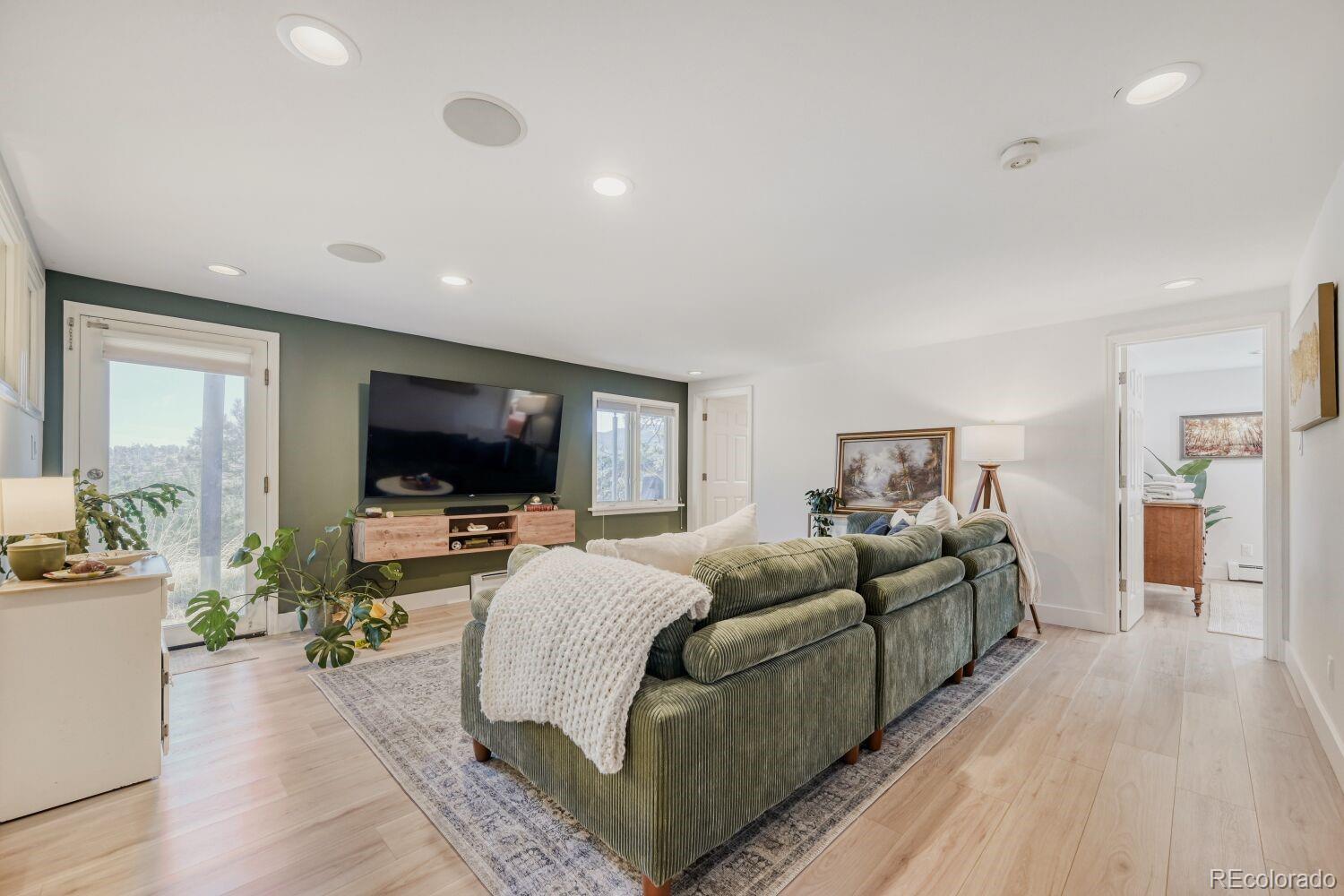 924 Kelly Road West Boulder, CO 80302 - Photo 29 of 44 a living room with furniture and a flat screen tv