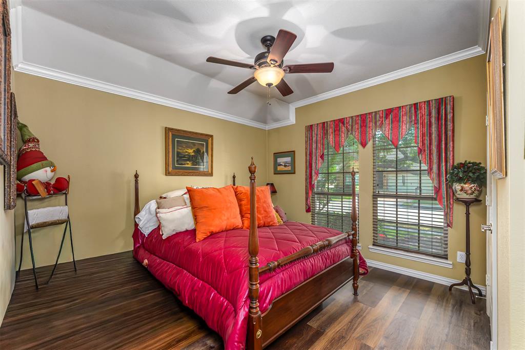 1601 Meadow Ranch Road McKinney, TX 75071 - Photo 17 of 31 Tray ceiling with crown molding, wood-finish flooring, and a ceiling fan with integrated lighting