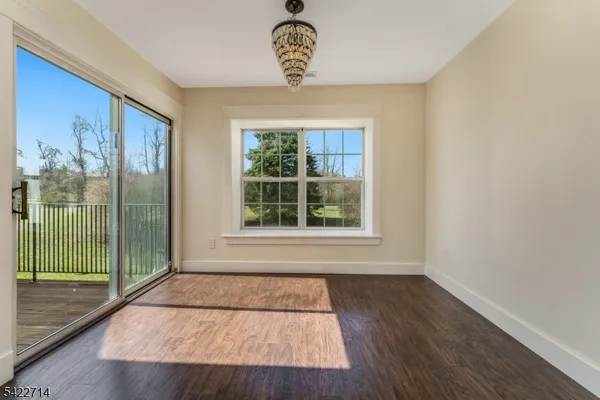 a view of a room with wooden floor and a window