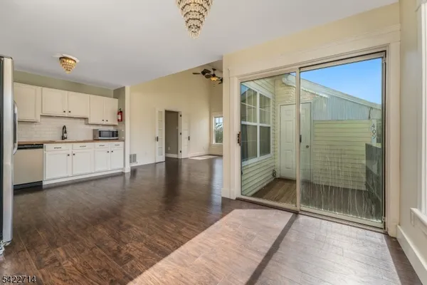 a spacious bathroom with a glass shower door and a bathtub