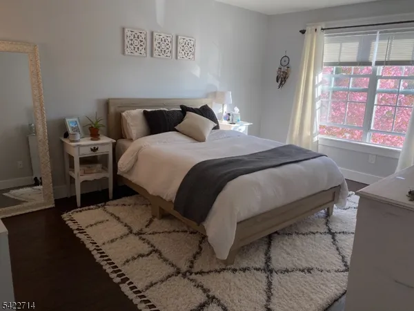 a bedroom with a bed and window