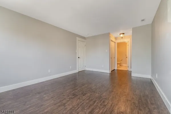 a view of an empty room and wooden floor