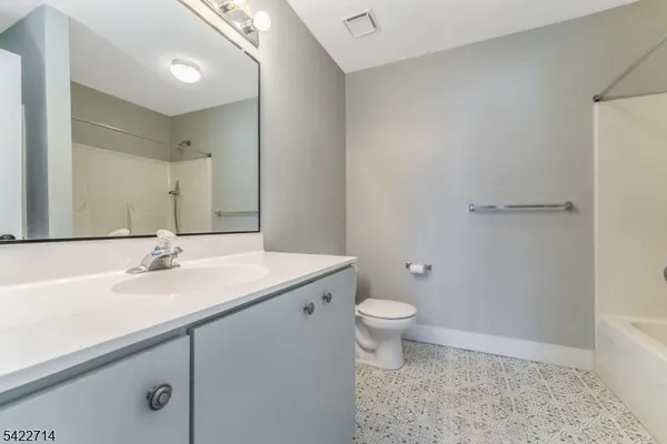 a bathroom with a sink a toilet a mirror and vanity