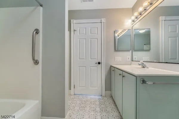 a bathroom with a sink a mirror and a bathtub