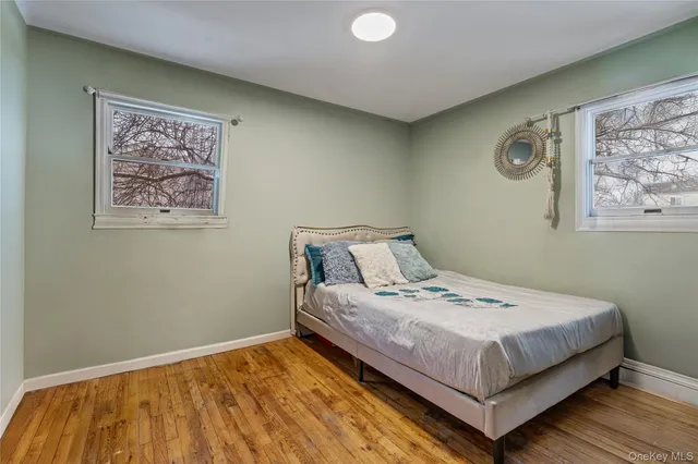 a bedroom with a bed and wall painting with wooden floor