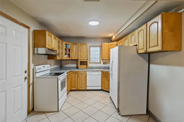 a kitchen with a refrigerator a stove top oven
