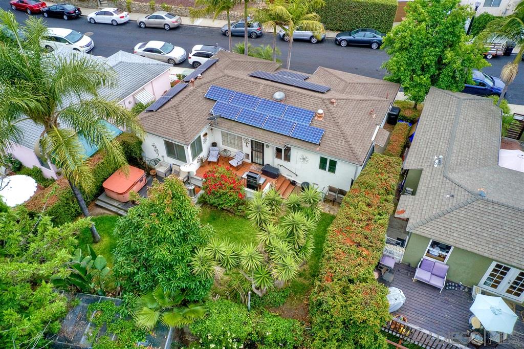 an aerial view of a house with a yard basket ball court and outdoor seating